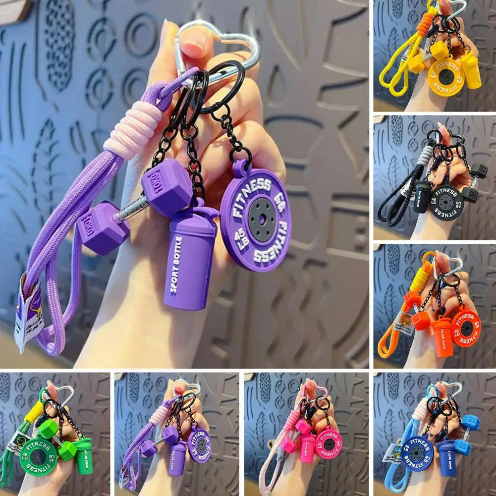 Various fitness keychains featuring dumbbells, kettlebells, and other workout charms.