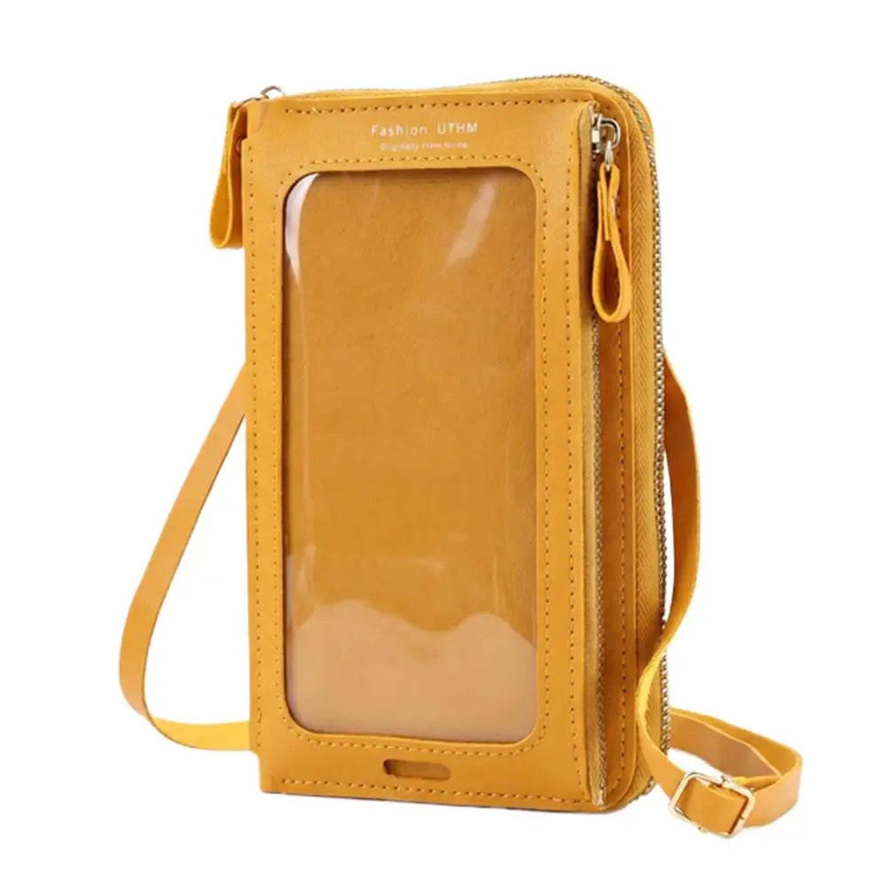 Tan Lederhandtasche mit klarem Frontpanel und Trageriem, vor weißem Hintergrund.