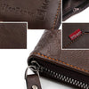 Close-up of a dark brown PU leather wallet showing stitching, a coin pocket, and a leather tag.