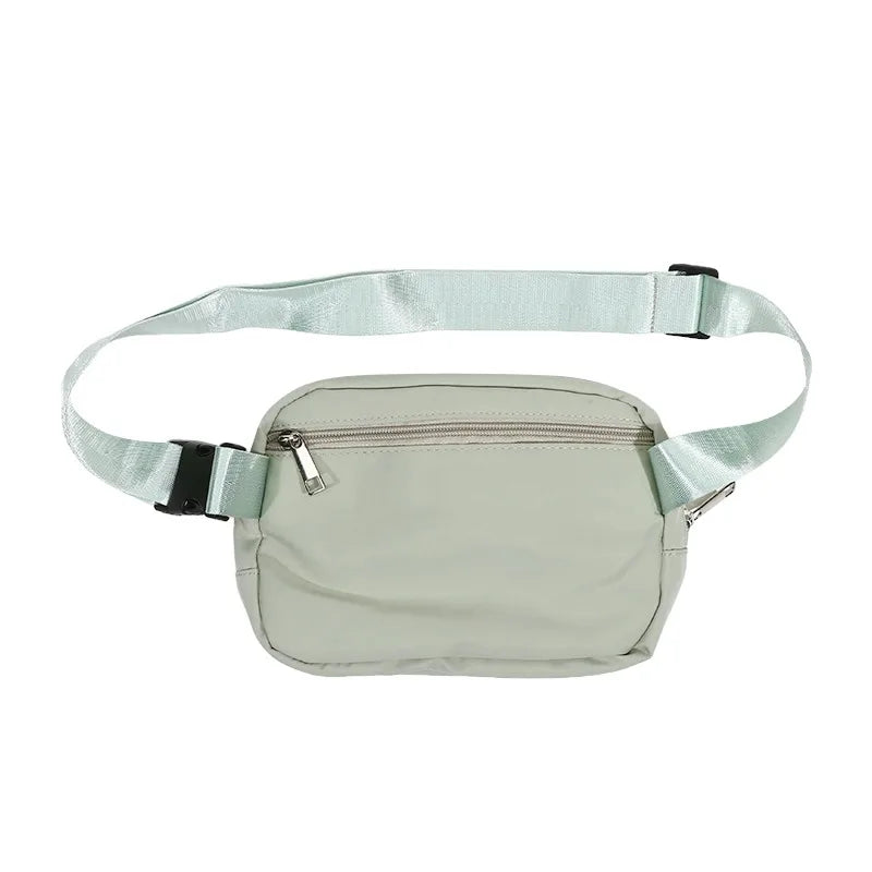 A light mint green waist bag or fanny pack with a strap and zipper.