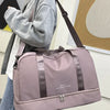 A light pink expandable nylon travel duffle bag is carried by a person, shown in a side view.