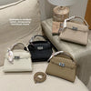 A collection of elegant PU leather crossbody clutch bags in various neutral tones displayed on a light fabric surface.