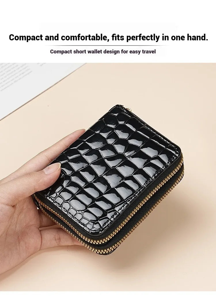 A black PU leather double zipper wallet is held in a hand, showcasing its compact design.