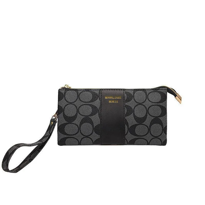 A black and gray patterned faux leather mini crossbody bag with gold hardware.