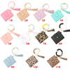 Eleven silicone bead bracelets and leather card holders in various shades of pink, mint green, and black.