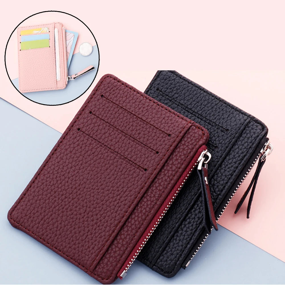 A dark maroon PU leather card holder wallet with a black zipper and keychain is shown next to a pink leather wallet.