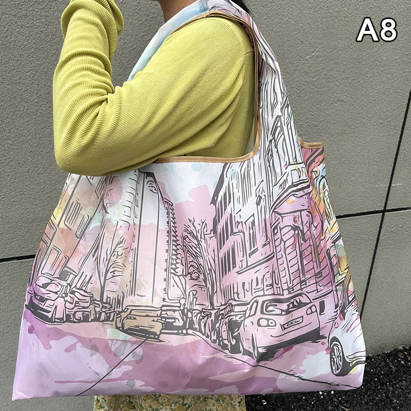 A woman holds a large, light pink and white floral print nylon shopping tote bag.