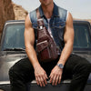 A man wearing a denim shirt sits on the hood of a dark car with a brown leather sling backpack.