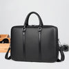 A black luxury PU leather business briefcase with silver hardware is shown on a light background.