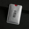 A silver anti-RFID blocking card holder is shown against a dark background.