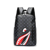 A black plaid laptop backpack with a red and white shark mouth design on the front.