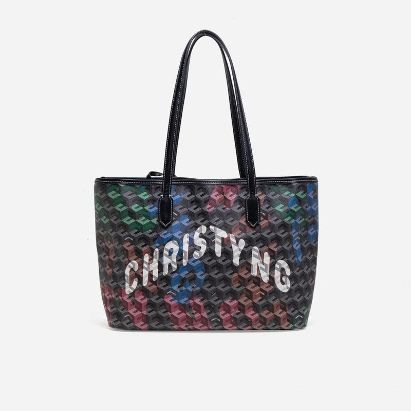 A black and multicolored geometric print tote bag with a handle.