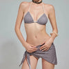 A model wearing a gray and white gingham bikini set with a halter top and low-rise bottoms.