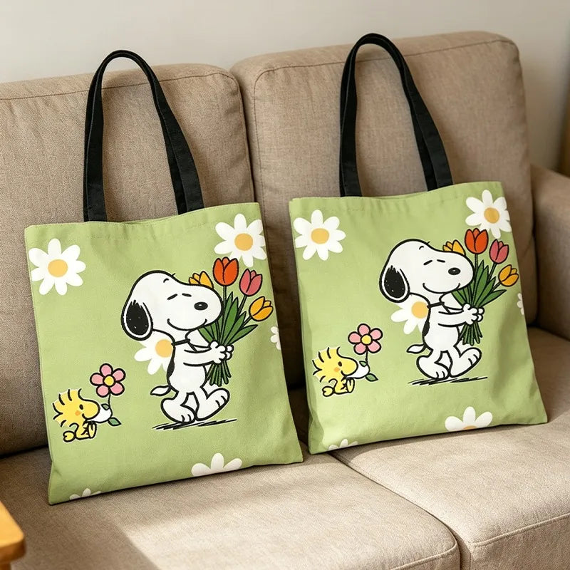 A light green canvas tote bag featuring a cartoon illustration of a dog holding a bouquet of colorful flowers.