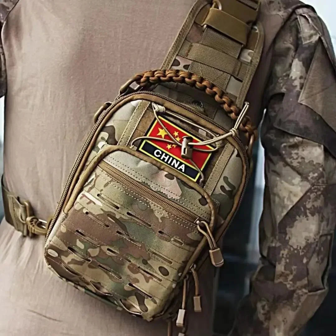 A tactical sling bag with a camouflage pattern is worn on a person's shoulder.