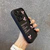 A hand holds a black silicone phone case with pink bows and the text With God All Things Are Possible printed on it.