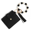 Black leather card wallet with a gold-toned chain and white and black silicone beads.
