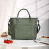 A green insulated lunch bag with a handle is displayed on a white table.