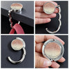 A round silver metal bag hanger with a curved hook is shown in various angles and on a hand.