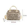 A beige floral corduroy insulated lunch bag with a leopard print pattern.