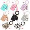 Eight different colored silicone PU leather key chain wristlet wallets displayed in various shades and styles.