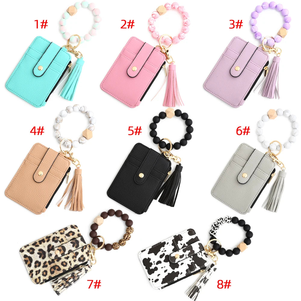 Eight different colored silicone PU leather key chain wristlet wallets displayed in various shades and styles.