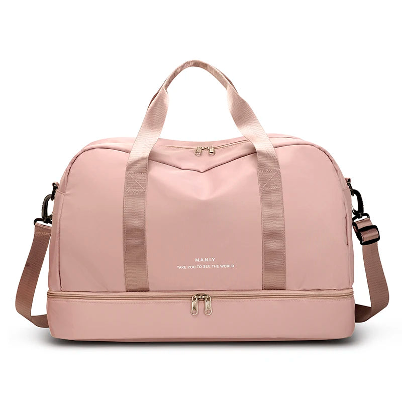 A light pink expandable nylon travel duffle bag with pink straps and hardware.