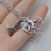 Silver keychain set featuring a cowboy boot, hat, and horseshoe charms on a silver chain