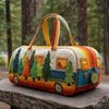 A quilted travel duffle bag shaped like a vintage bus with colorful trees and windows in a forest setting.