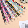 A collection of colorful floral patterned nylon crossbody bag straps with metal buckles laid out on a light background.