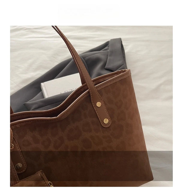 A close-up of a brown leopard print tote bag resting on a light-colored surface.