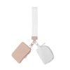 A small pink nylon zip wristlet coin purse with a white strap is shown against a white background.