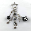 Silver Y2K 8 ball keychain charm featuring a star and black and white dice.