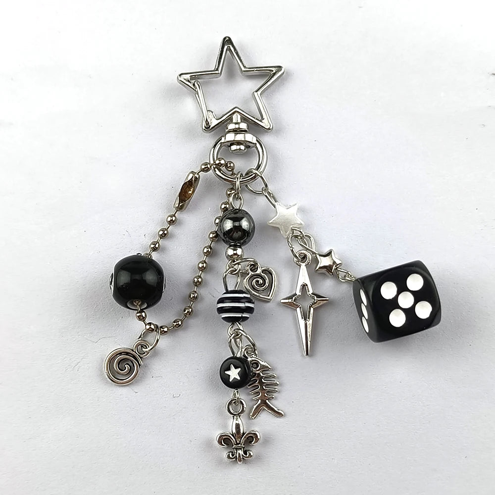 Silver Y2K 8 ball keychain charm featuring a star and black and white dice.