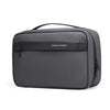 A dark gray travel toiletry organizer bag with a black handle and a subtle logo detail.