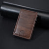 A brown PU leather card holder wallet resting on a black cylindrical object.