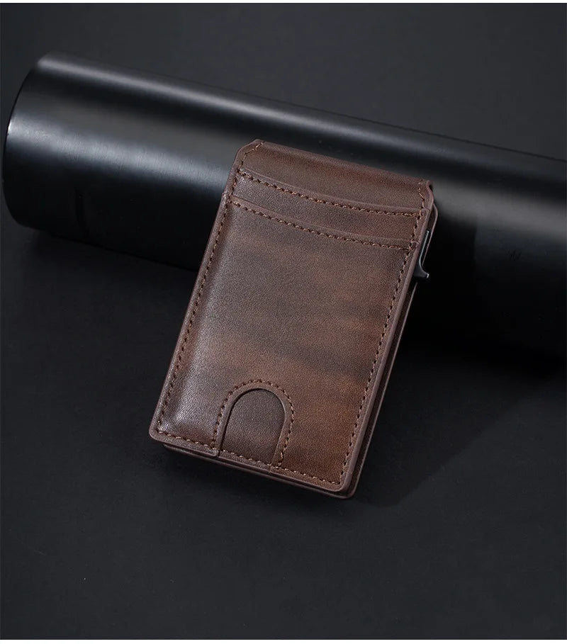 A brown PU leather card holder wallet resting on a black cylindrical object.