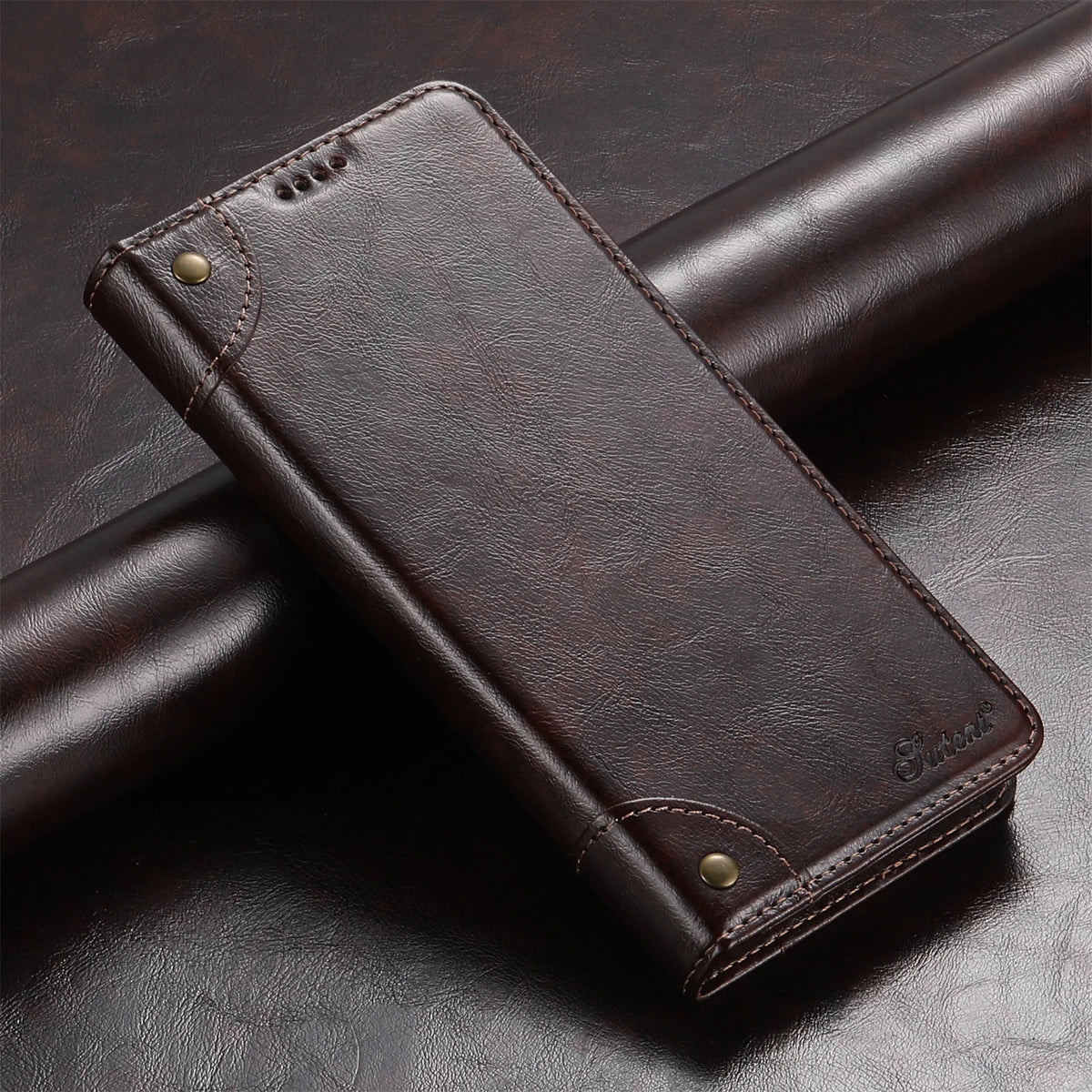 A dark brown magnetic leather flip case with a card holder resting on a dark surface.