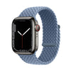 A dark gray Apple Watch is shown attached to a light blue braided stretch band.