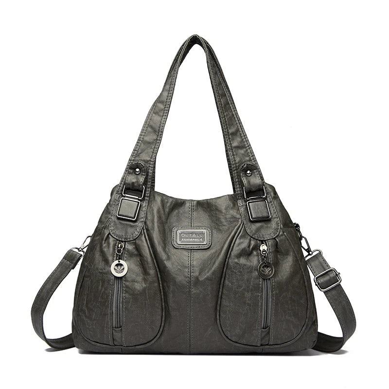 Schwarze Vintage-Handtasche aus weichem Kunstleder mit Klappverschluss und Lederverzierung.