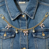 A denim jacket adorned with a gold chain necklace featuring pink bows and pearl charms.