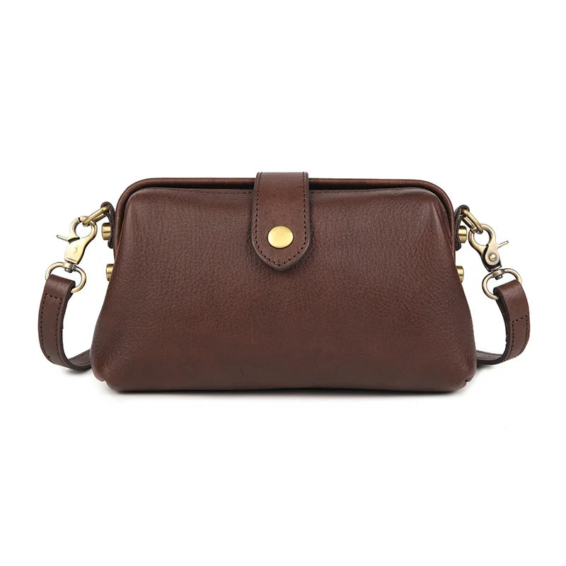 A brown genuine leather crossbody bag with a flap and gold-toned hardware.