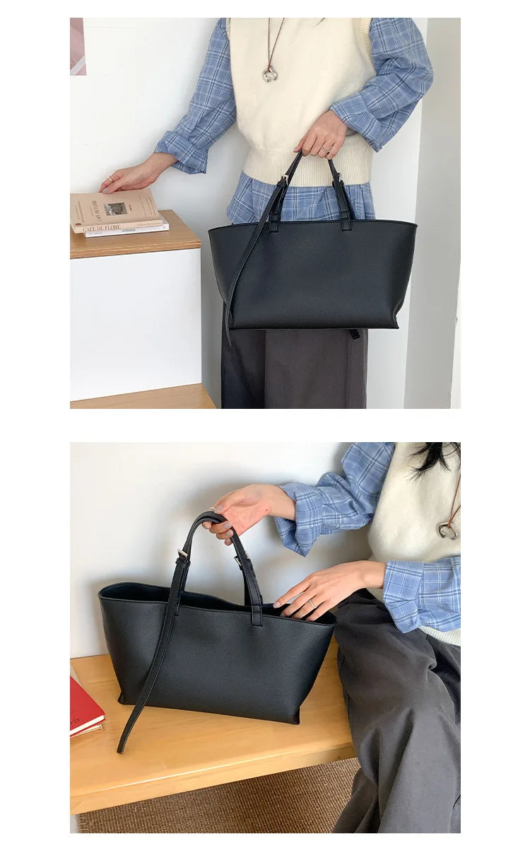 Une personne tient un sac fourre-tout en cuir PU noir contre un mur blanc.