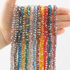 A hand holds multiple strands of colorful AB faceted crystal glass beads for jewelry making