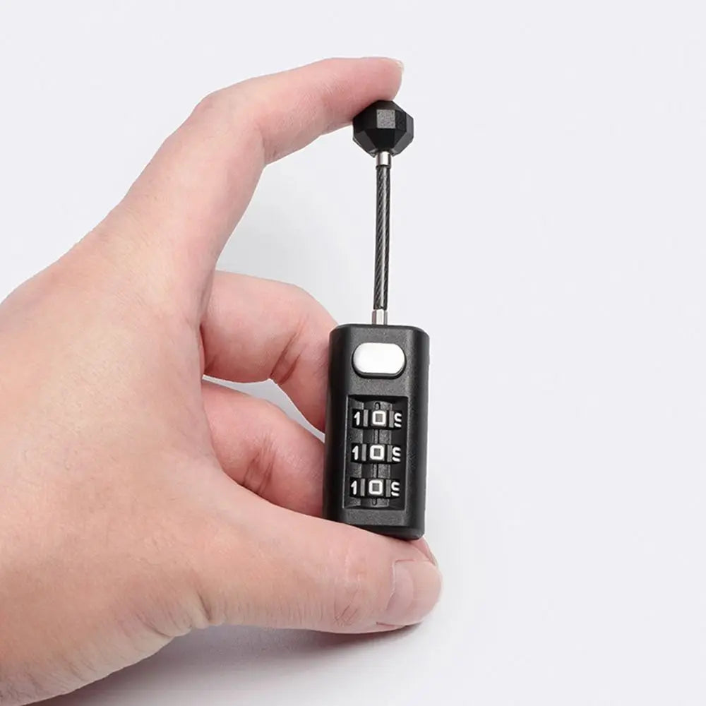 A hand holds a black resettable 3-digit combination padlock with a long metal shackle.