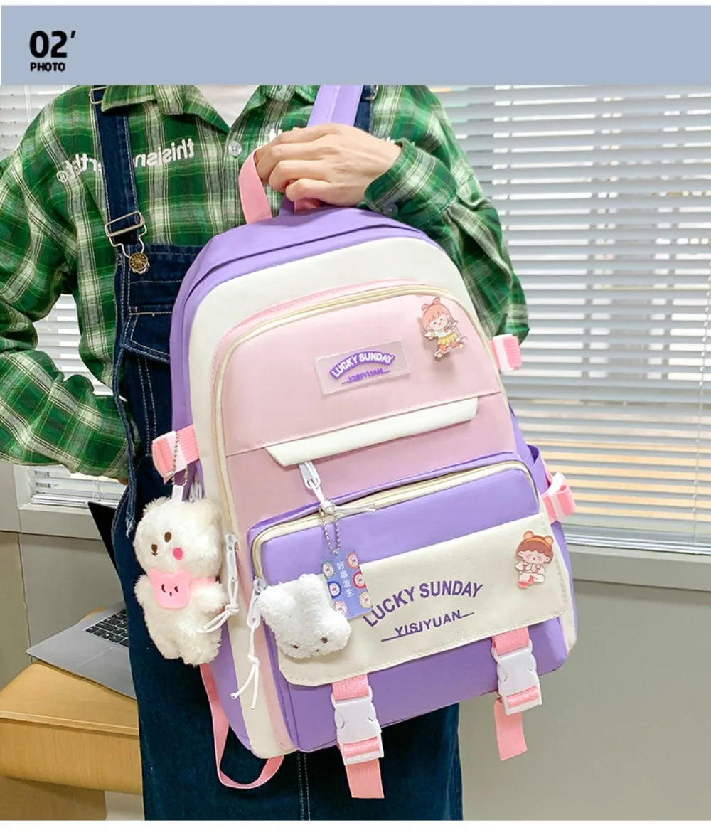 A purple and pink nylon backpack set with cartoon designs is carried by a person wearing a green plaid shirt.