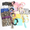 Assortment of silicone bead bracelets and leather card holders in various colors and patterns