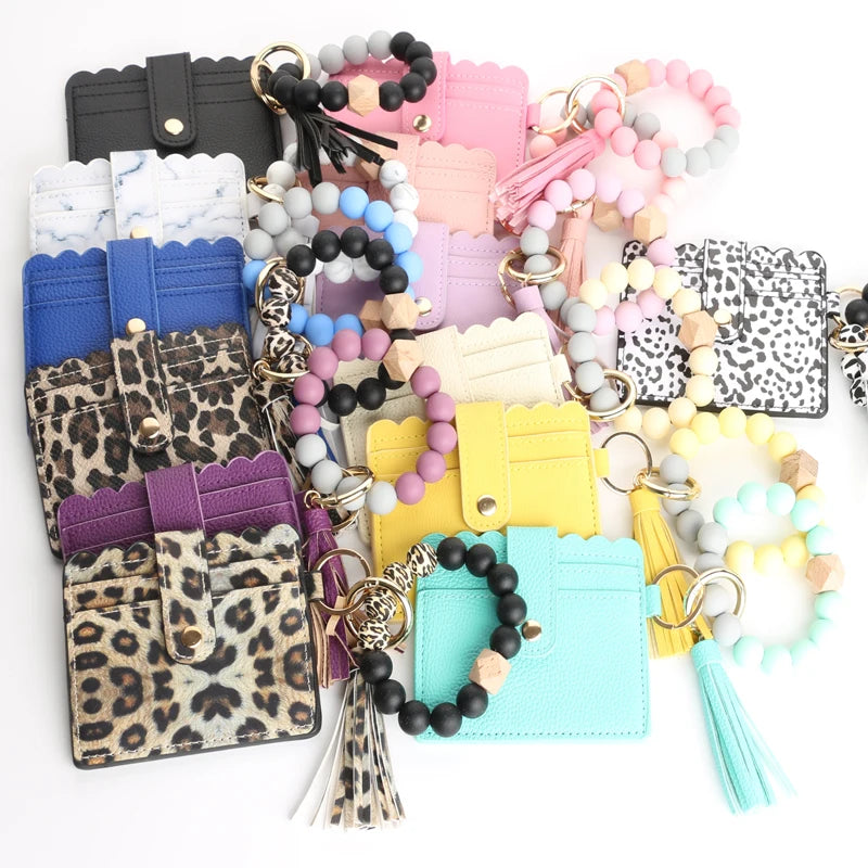 Assortment of silicone bead bracelets and leather card holders in various colors and patterns