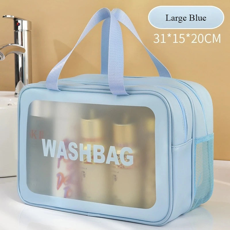 A light blue double-layer clear wash bag with a strap, shown next to a faucet.