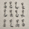 A collection of stainless steel alphabet letter charms, including O, C, W, Z, L, R, U, X, S, L, M, and D, with lobster clasps